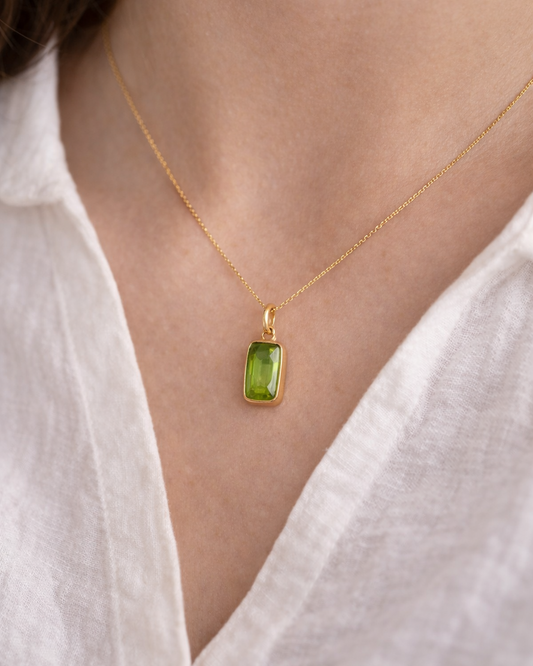 woman wearing peridot rectangle pendant necklace minimal elegant jewelry