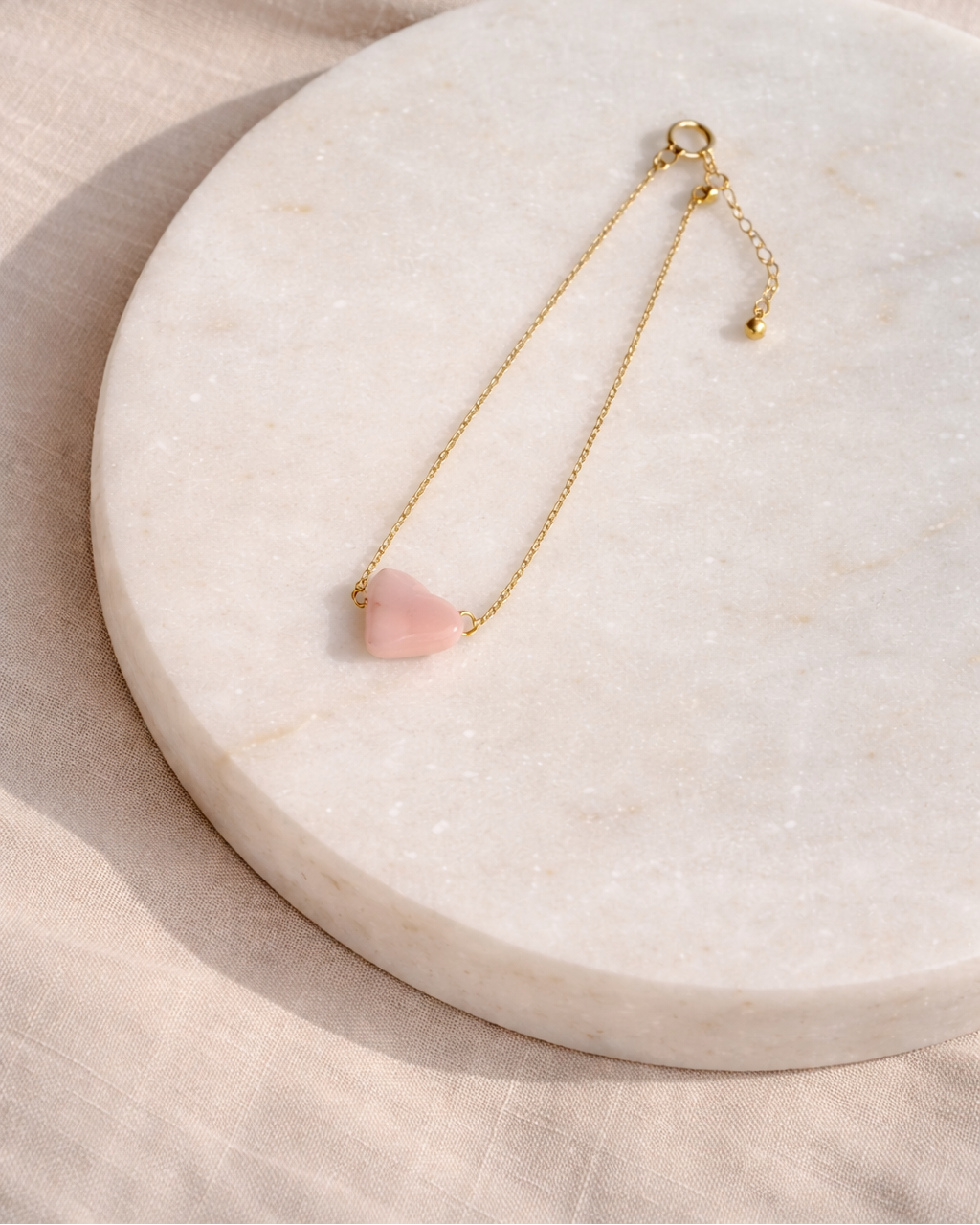 close up of pink opal cloud bracelet showing soft blush stone and gold chain
