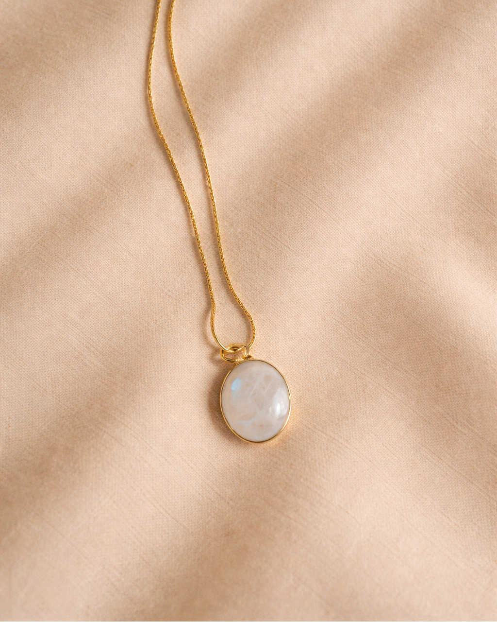 rainbow moonstone oval mens pendant showing natural iridescent white stone