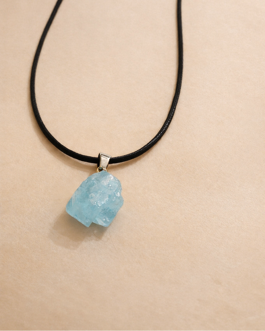 raw aquamarine pendant necklace showing natural light blue stone