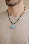 person wearing raw aquamarine pendant minimal jewelry