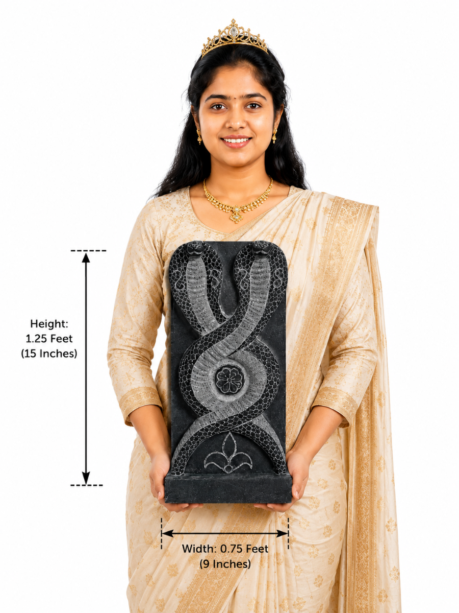Hand-carved 1.25 ft Nagaraja and Nagini serpent pair in polished black stone shown with an adult model for scale.