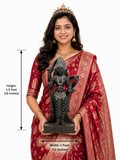 Hand-carved 1.5 ft Brahmi Sapta Matrika statue in polished black stone shown with an adult model for scale and measurements.