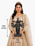 Hand-carved 1.5 ft Kali Amman statue in polished black stone shown beside an adult model for scale and measurements.