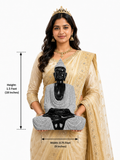 Hand-carved 1.5 ft meditative sitting Buddha statue in polished black stone shown beside an adult model for scale and measurements.