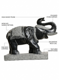 Hand-carved 1.5 ft temple guardian elephant statue in natural stone, product view 2 highlighting the animal form and carved details.