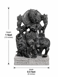 Hand-carved 1 ft Venugopala Krishna statue in polished black stone shown beside an adult model for scale.