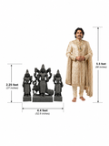 Hand-carved 2.25 ft Subramanya Swamy with Valli and Deivanai statue in polished black stone shown with an adult model.