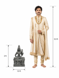 Hand-carved Mahalakshmi statue in polished black stone shown beside an adult model for scale with measurements.