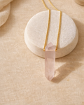 rose quartz mens bullet pendant on chain showing soft pink stone
