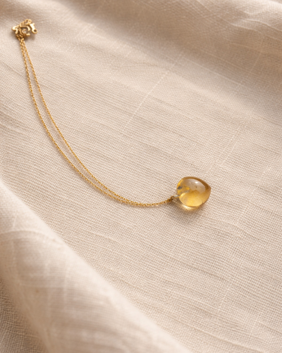 woman wearing topaz heart pendant necklace minimal elegant jewelry