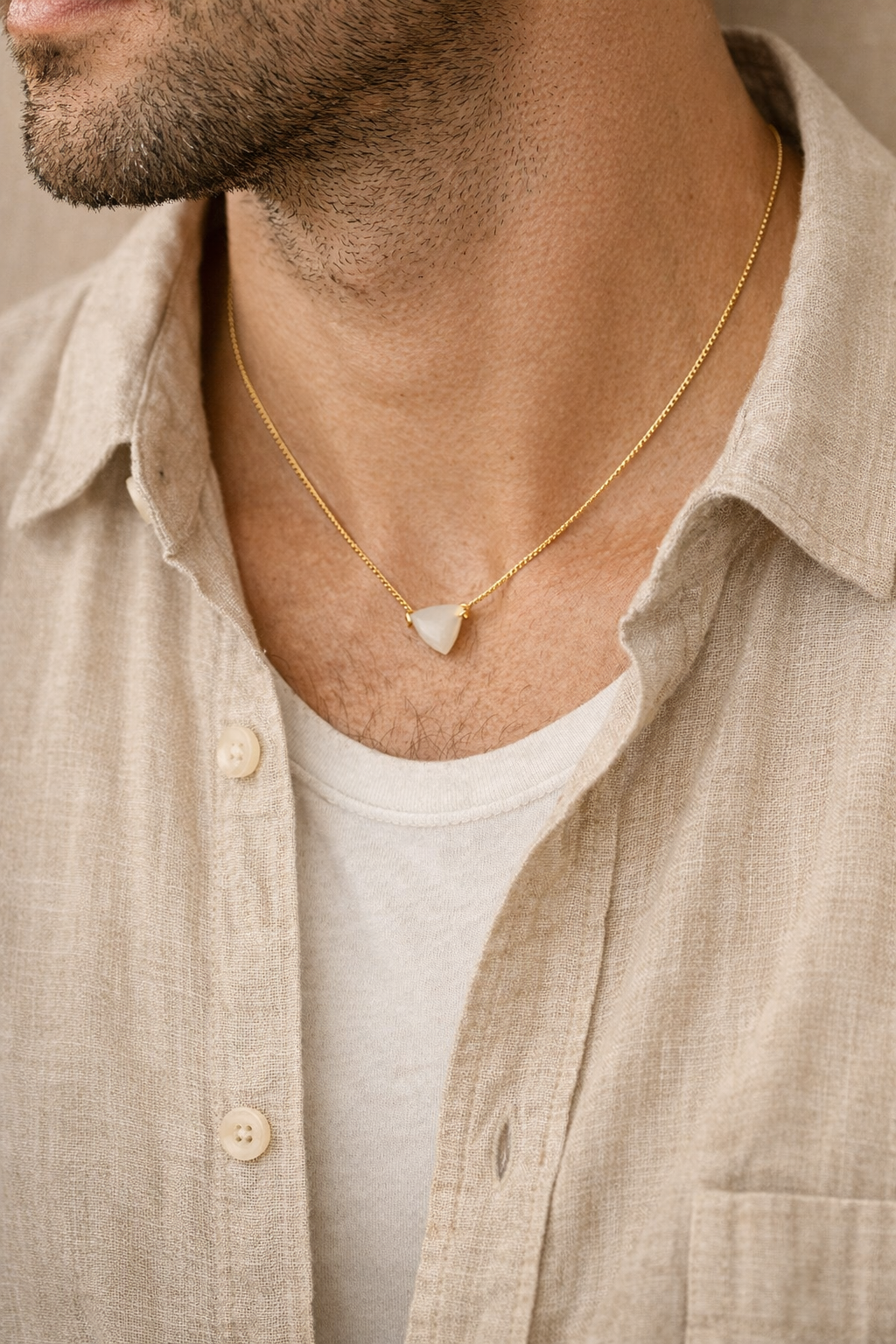 man wearing white moonstone tikona pendant minimal jewelry