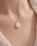 woman wearing white moonstone star pendant necklace minimal elegant jewelry